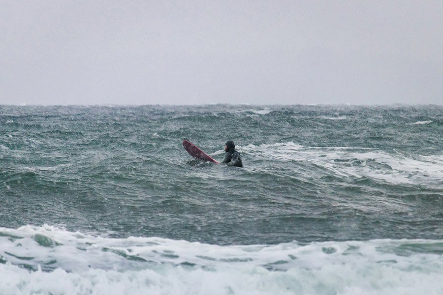 Surfing in winter icy water