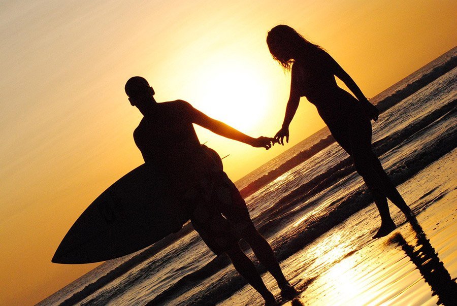 silhouette of surfers