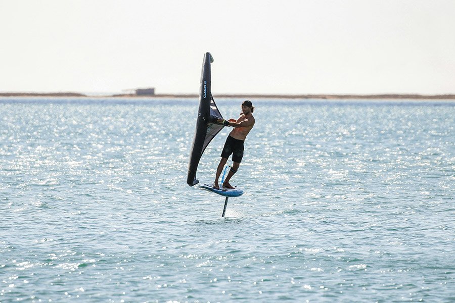 Wing foil surfing on calm sea